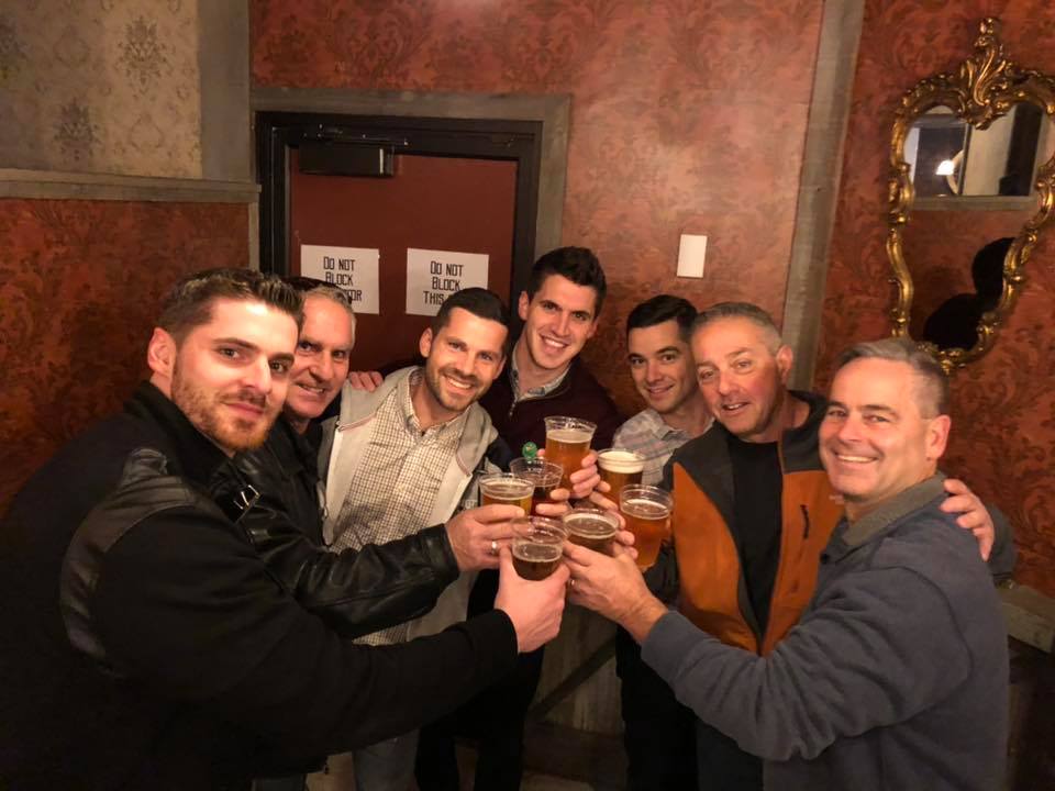 Bachelor Party Pub Crawl – Thumbnail Image a group of people sitting at a table with wine glasses