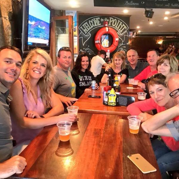 a group of people sitting at a table posing for the camera