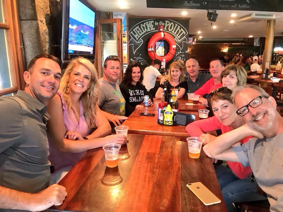 a group of people sitting at a table posing for the camera